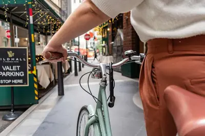 a person riding a bike down a street at Gild Hall, A Thompson Hotel, by Hyatt in New York