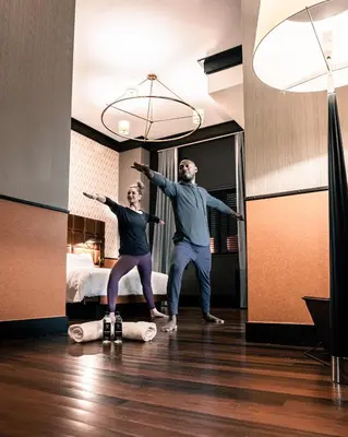 a man and woman are dancing in a hotel room at Gild Hall, A Thompson Hotel, by Hyatt in New York