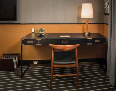 a desk with a lamp and a chair in a room at Gild Hall, A Thompson Hotel, by Hyatt in New York