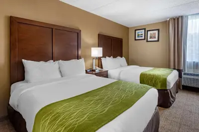 a hotel room with two beds and a window at Comfort Inn Edison - New Brunswick in Edison