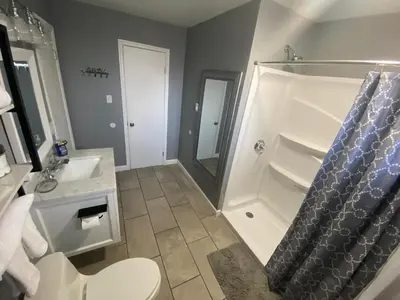a bathroom with a shower and a toilet and a sink at A Modern Apt close to downtown in Lancaster