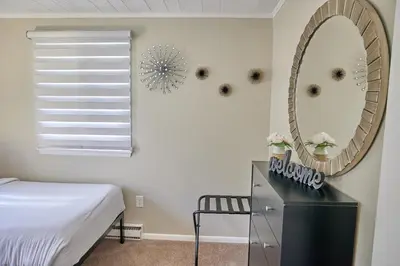 a bedroom with a bed and a mirror on the wall at A Modern Apt close to downtown in Lancaster