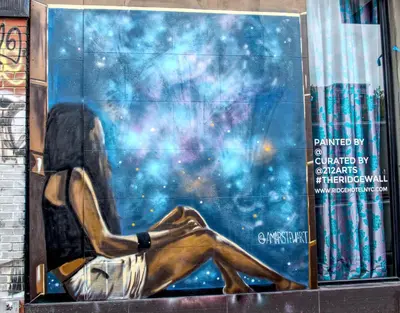 a painting of a woman sitting on a wall at The Ridge in New York