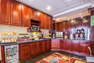 a large kitchen with wooden cabinets at Comfort Suites at Woodbridge in Avenel