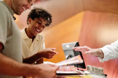 a group of people standing around a table with a laptop at The Westin New York at Times Square in New York