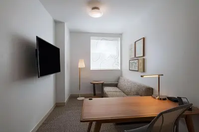 a living room with a couch and a tv at Element Spring Valley in Spring Valley