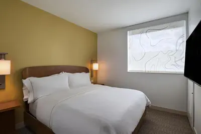a bedroom with a white bed and a window at Element Spring Valley in Spring Valley