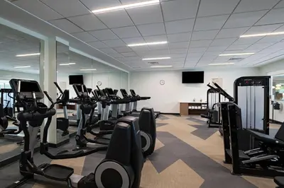 a gym with rows of treadmills and elliptical machines at Element Spring Valley in Spring Valley