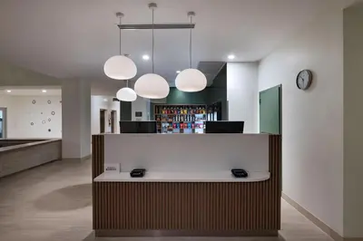 a lobby with a reception desk and lights at Element Spring Valley in Spring Valley