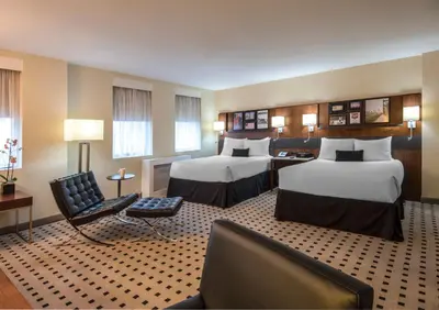 a hotel room with two beds and a couch at The Warwick Hotel Rittenhouse Square Philadelphia in Philadelphia