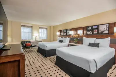 a hotel room with two beds and a desk at The Warwick Hotel Rittenhouse Square Philadelphia in Philadelphia