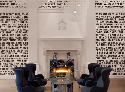 a living room with two chairs and a fireplace at The Warwick Hotel Rittenhouse Square Philadelphia in Philadelphia
