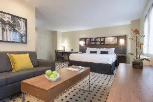 a hotel room with a bed and a couch at The Warwick Hotel Rittenhouse Square Philadelphia in Philadelphia