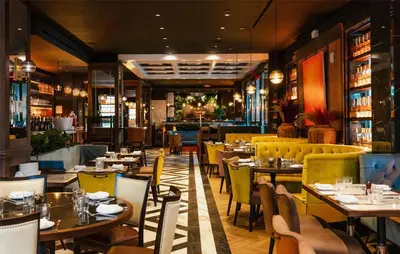 a restaurant with tables and chairs in a room at NH Collection New York Madison Avenue in New York