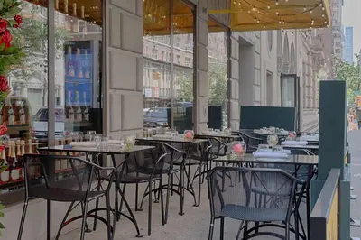 a row of tables and chairs on a city street at NH Collection New York Madison Avenue in New York