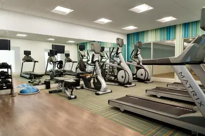 a gym with treadmills and elliptical machines at Holiday Inn Express - Wilmington North - Brandywine by IHG in Wilmington
