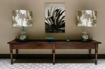 a wooden table with two vases on top of it at The Broome in New York