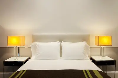 a bedroom with a bed with two lamps on both sides at The Broome in New York