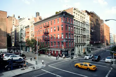 a busy city street with cars and people and buildings at The Broome in New York