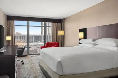a hotel room with a large bed and a desk at Delta Hotels by Marriott Somerset in Somerset
