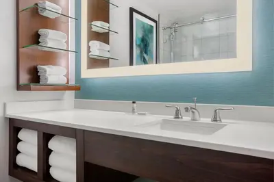 a bathroom with a sink and a mirror and towels at Delta Hotels by Marriott Somerset in Somerset