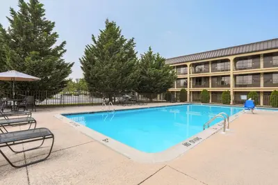 a large swimming pool in front of a building at Days Inn by Wyndham Newark Wilmington in Newark