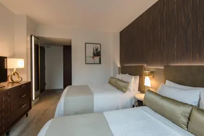 a hotel room with two beds and a couch at Marriott Vacation Club®, New York City  in New York