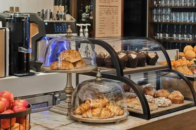 a bakery with two tiers of bread and pastries on a counter at Marriott Vacation Club®, New York City  in New York