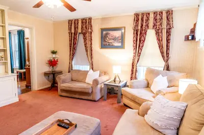 a living room with two couches and a table at CHARMING EXECUTIVE VICTORIAN MANSION w/ FREE PARKING - near Bucknell in Milton