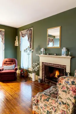 a living room with a couch and a fireplace at CHARMING EXECUTIVE VICTORIAN MANSION w/ FREE PARKING - near Bucknell in Milton