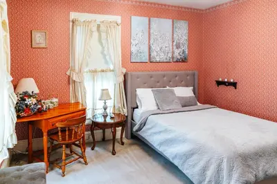 a bedroom with a bed and a desk next to a window at CHARMING EXECUTIVE VICTORIAN MANSION w/ FREE PARKING - near Bucknell in Milton