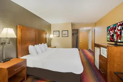 a hotel room with a large bed and a flat screen tv at Red Roof Inn Fairfield in Fairfield
