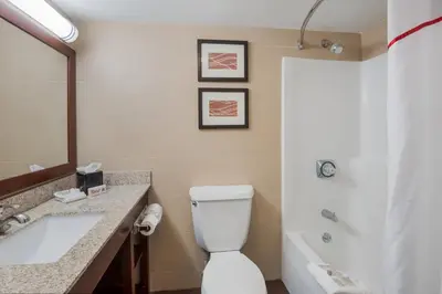 a bathroom with a toilet and a sink and a tub at Red Roof Inn Fairfield in Fairfield