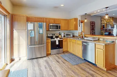 a kitchen with wooden cabinets and stainless steel appliances at Northridge 199 in Tannersville
