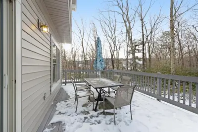 a table and chairs on a porch covered in snow at Northridge 199 in Tannersville