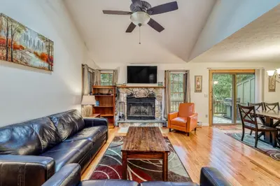 a living room with a leather couch and a fireplace at Northridge 410 in Tannersville