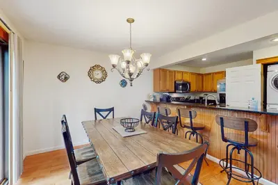 a dining room with a wooden table and chairs at Northridge 410 in Tannersville