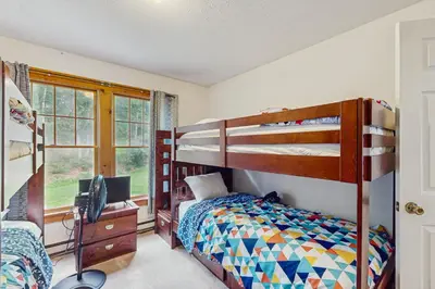 a bedroom with bunk beds and a desk with a computer at Northridge 410 in Tannersville