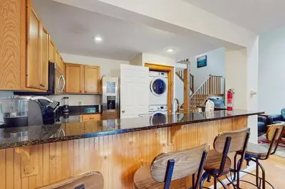 a kitchen with a counter with chairs in it at Northridge 410 in Tannersville