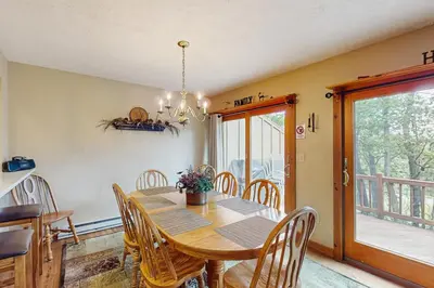 a dining room with a wooden table and chairs at Northridge 467 in Tannersville
