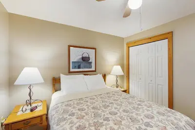 a bedroom with a bed and two lamps and a door at Northridge 467 in Tannersville