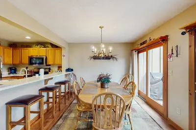 a kitchen and dining room with a wooden table and chairs at Northridge 467 in Tannersville