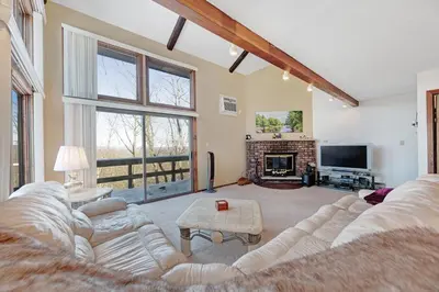 a living room with a couch and a fireplace at Camelback 302 in Tannersville