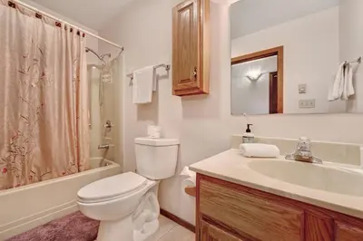 a white bathroom with a toilet and a sink at Camelback 302 in Tannersville
