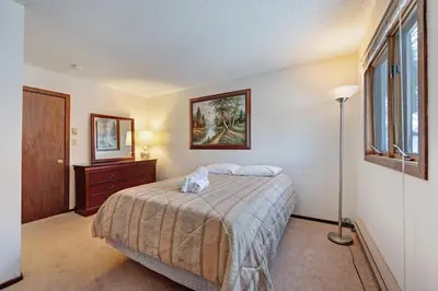 a bedroom with a bed and a dresser and a window at Camelback 302 in Tannersville