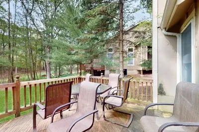 a patio with chairs and a table on a deck at Northridge 482 in Tannersville