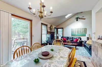 a dining room and living room with a table and chairs at Northridge 482 in Tannersville