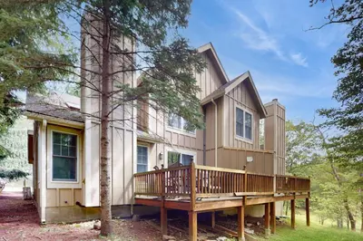 a house with a porch and a deck at Northridge 482 in Tannersville