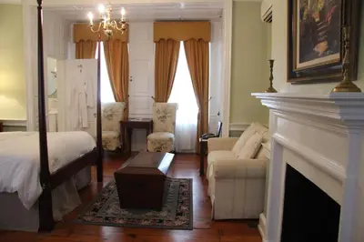 a bedroom with a fireplace and a bed and a couch at Morris House Hotel in Philadelphia