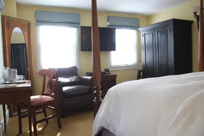 a bedroom with a bed and a chair and a desk at Morris House Hotel in Philadelphia